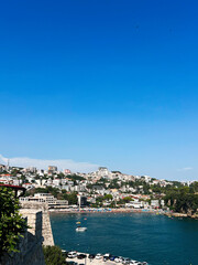 Obraz premium Idyllic coastal town with vibrant blue sky and serene bay. Ulcinj, Montenegro