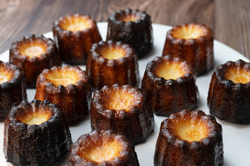 Caneles de bordeaux, traditional French sweet dessert with white table background, High quality photo