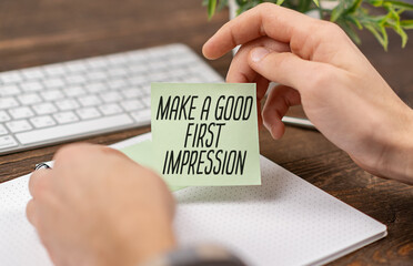 Businessman holding a card with text Make a good first impression