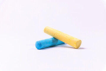Crayons of different colors arranged on a white background. Education