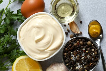 Bowl with mayonnaise on gray background