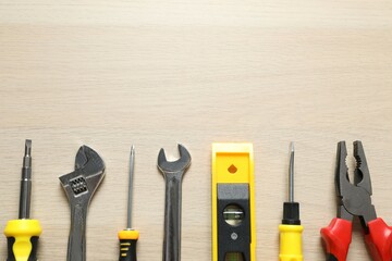 Set of tools on wooden background, top view
