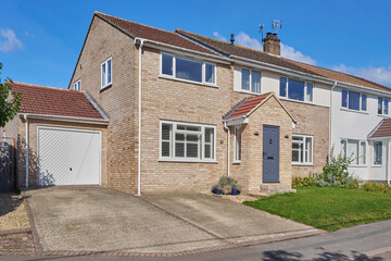 Exterior Of  Typical UK Semi Detached House Or Home Viewed From Front Elevation With Garage