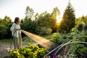A woman waters her garden in the early morning, surrounded by lush greenery and a stunning mountain view. The peaceful moment captures the essence of life in harmony with nature