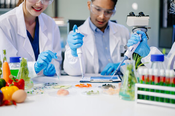 Dynamic scene of food scientists using microscopes and pipettes in a lab,