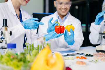 Dynamic scene of food scientists using microscopes and pipettes in a lab,