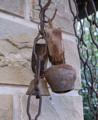Hanging rusty cowbells as decoration at an old farmhouse