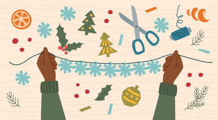 Sustainable Christmas concept. Eco friendly handmade decoration. Person makes ecological Christmas snowflake garland from paper.