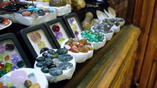 Rows of different semiprecious stones at traditional middle eastern bazaar. Jewelry gemstones for sale at Khan El Khalili bazaar, Cairo, Egypt