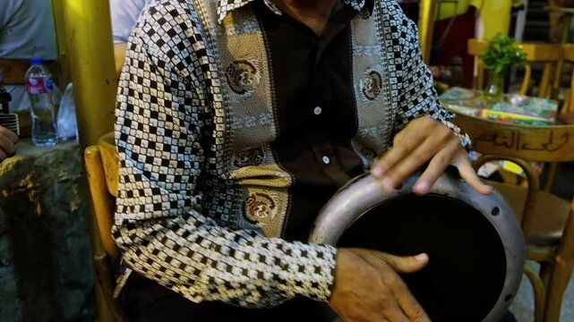 Hands of men playing oud and darbuka, traditional egyptian tabla drum. Traditional egyptian music performance at Khan El Khalili bazaar, Cairo, Egypt