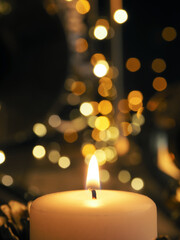 Festive Christmas decoration with one burning candle and brass instruments