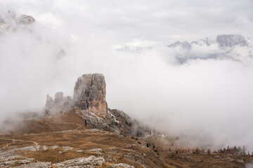 Cinque torri surrounded by fog high in the Italian Dolomites