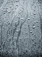 rain water drops on a bonnet of a black car during rainy day