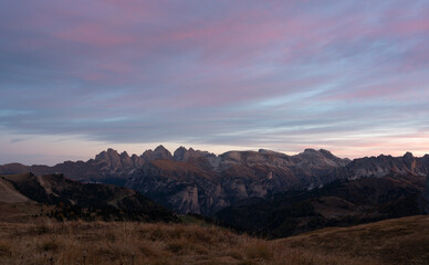 Soft purple sunrise above the dolomites in the fall