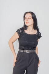 Fototapeta premium Cute young brunette standing on a white background. Copy space