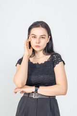 Cute young brunette girl standing on a white background. Copy space