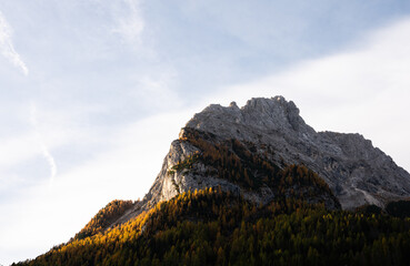 Morning autumn light on the cliffs of Colac Peak in the Italian Dolomites