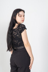 Pretty young brunette posing with her back on a white background. Copy space