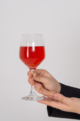 Wine glass in womans hands close up on a white background