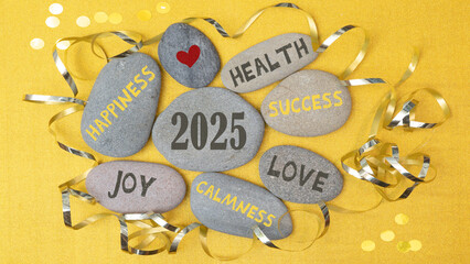 Happy New Year 2025, New Year, New Year's Eve party greeting card postcard with text - stones with New Year's wishes on golden table background, top view
