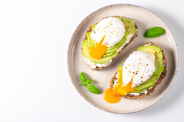 Two avocado open sandwiches with egg. Keto and diet concept. Healthy toast food for breakfast.