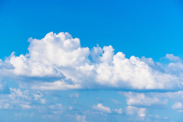 Fluffy White Clouds Adrift in Vibrant Blue Sky