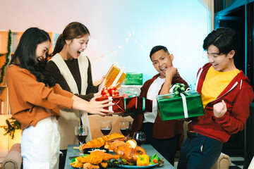 Dinner and group of people celebrating together at Merry Christmas and New Year.