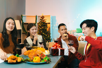 Dinner and group of people celebrating together at Merry Christmas and New Year.