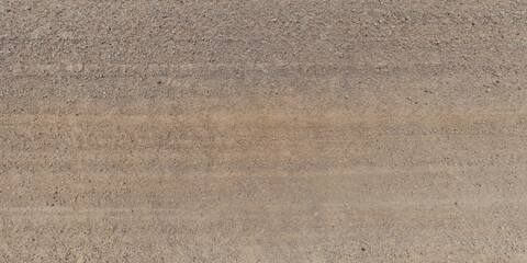 panorama view from above on texture of gravel sand road with car tire tracks