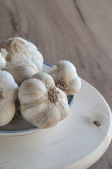 Fresh organic garlic bulbs and cloves on wooden table. Close up. 