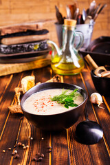 Musroom soup served with parsley leaf.