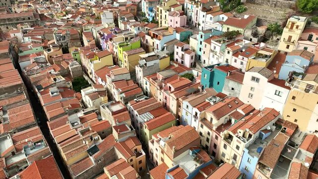 Aerial view of colorful rooftops and charming houses in a picturesque village, Bosa, Italy.