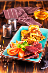 omelet with smoked meat, tomato and spice