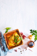 peppers stuffed with meat, rice and vegetables in wooden bowl