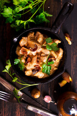 meat with mushroom sauce in pan