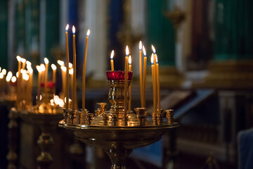 The church candles are burning. Inside the chapel in the semi-darkness.