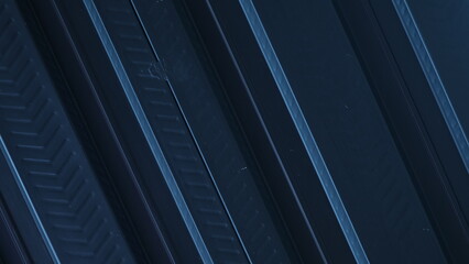 Obraz premium A sleek, metallic black backdrop, adorned with parallel lines, creates a futuristic aesthetic, evoking images of high-tech machinery and interstellar travel. ideal for a futuristic concept, copy space