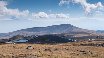 Mountain village near lake Kari nearby Mount Aragats, Armenia. Mount Ararat is in the background