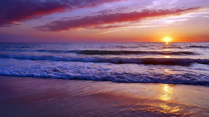 Fototapeta premium Beautiful sunset over the sea. Clear sandy beach and evening sunset over the sea.