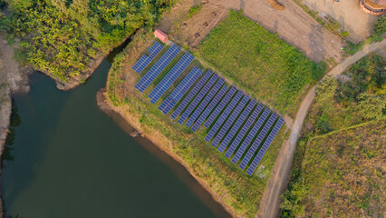Drone view of solar panel near water reservoir. Aerial Shot of many 