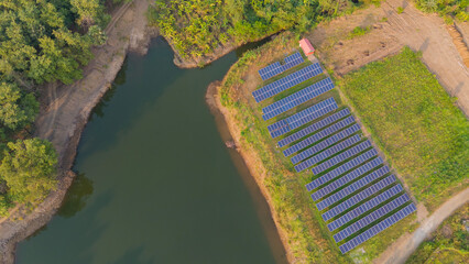 Drone view of solar panel near water reservoir. Aerial Shot of many 