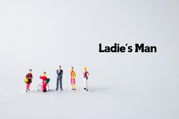 A miniature model group of handsome man and women is located on a white background. Relationship between man and woman.