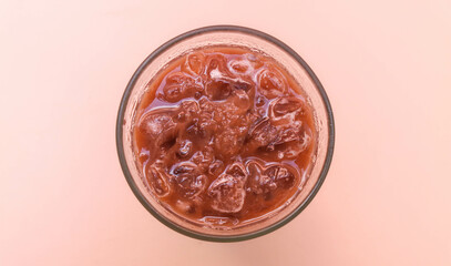 Top view Iced chocolate in clear glass isolated on pink background, copy space blank space