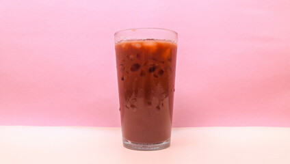 Iced chocolate in clear glass isolated on pink background, copy space blank space