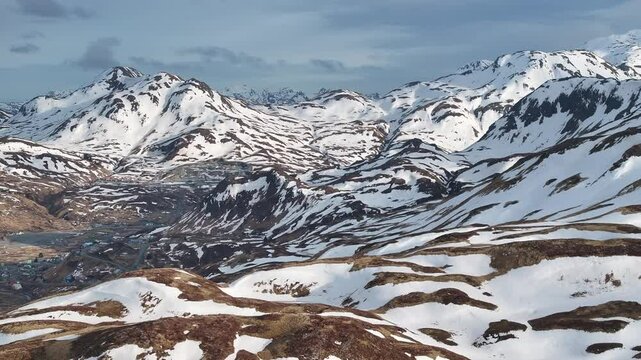 Aerial view of majestic snowy mountains in a breathtaking winter landscape, Unalaska, United States.