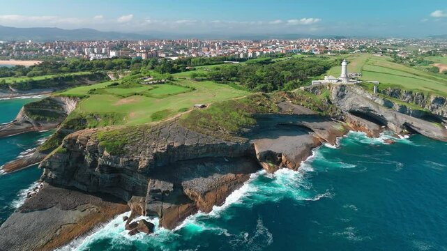 Aerial view of the Cape Mayor lighthouse on the rocky coast in Santander, Spain