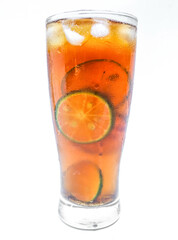 Close up Glass of iced tea with lemon, lime and ice cubes isolated on white background. A glass of sweet iced tea filled with lemon slices
