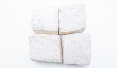 Fresh white tofu cubes on a white plate isolated white background. Fresh soybean tofu.