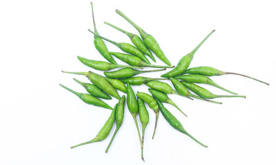 Collection of small green bird's eye chilies on a white plate isolated on a white background. Small hot bird's eye chilies for making chili sauce