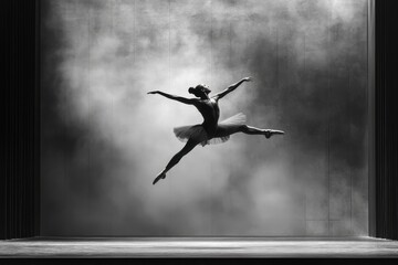 Graceful Ballerina Captured Mid-Leap in a Dramatic Black and White Performance